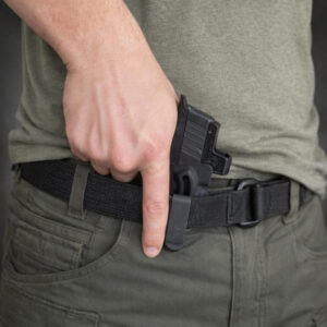 man with holster in appendix position drawing pistol