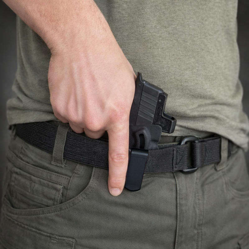 Man drawing pistol from appendix holster